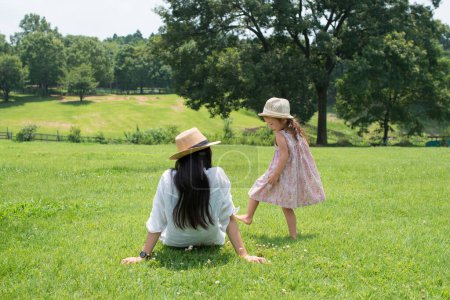 Téléchargez les photos : Mère et fille jouant dans la prairie - en image libre de droit