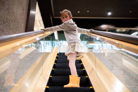 Photo for Asian girl walking on stairs, escalator - Royalty Free Image