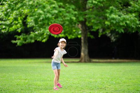 Photo for Girl playing with flying disc - Royalty Free Image