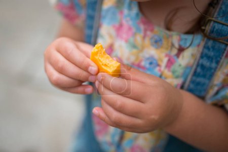 Kind mit Käse in der Hand