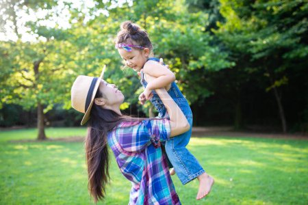 Photo for Mother and daughter playing in the park - Royalty Free Image