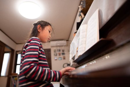 Photo for Girl to play the piano - Royalty Free Image