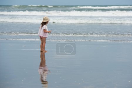 Photo for Little girl playing on the beach - Royalty Free Image