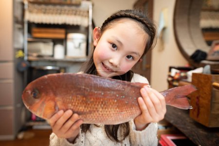 Téléchargez les photos : Fille sourire avec un poisson - en image libre de droit