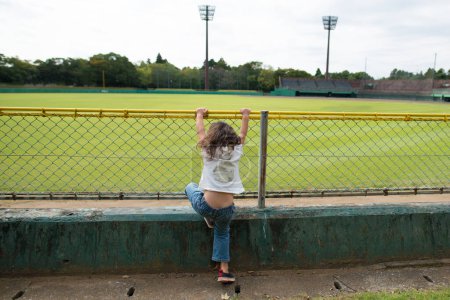 Photo for Girl to climb the fence - Royalty Free Image