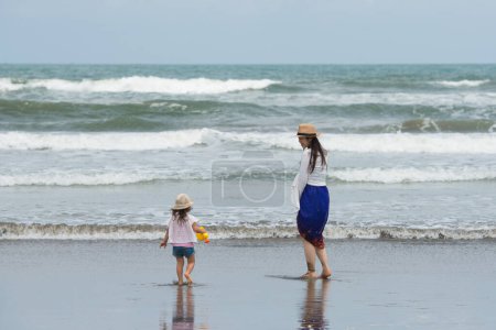 Photo for Mother and daughter playing in the sea - Royalty Free Image