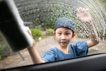 Photo for Girl washing a car with a sponge - Royalty Free Image