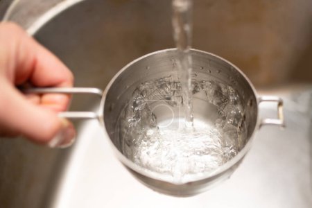 Photo for Pour water into measuring cup - Royalty Free Image