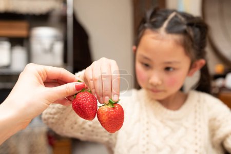 Photo for Parent and child toasting with strawberries - Royalty Free Image