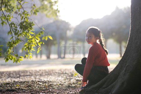 Photo for Girl sitting on a tree trunk - Royalty Free Image