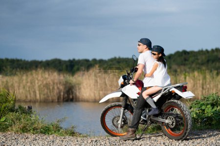 Father and daughter riding two seater off road bike