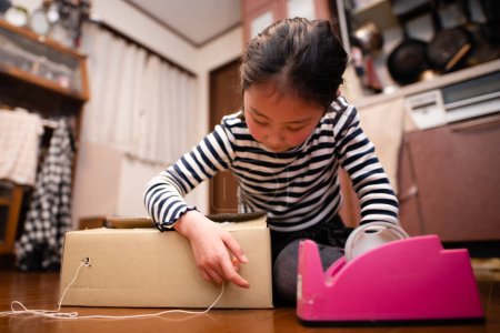 Photo for A girl playing with cardboard - Royalty Free Image