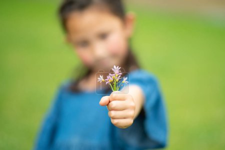 Foto de Niño sosteniendo una pequeña flor - Imagen libre de derechos