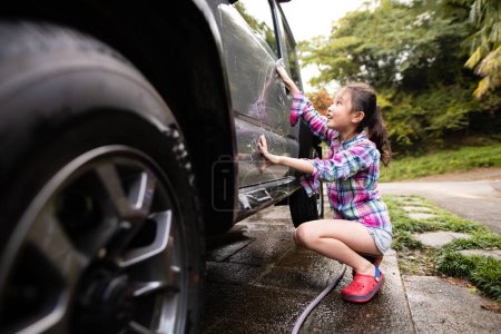 Téléchargez les photos : Fille mignonne laver une voiture - en image libre de droit