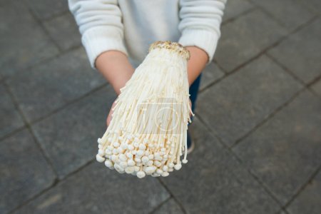 Child with enoki in hands
