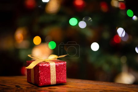 Photo for Christmas gift placed in front of the Christmas tree - Royalty Free Image