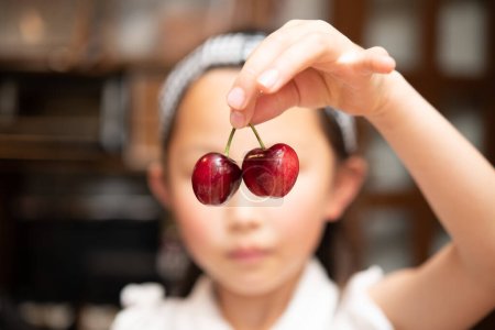 Photo for Girl picking up with a cherries - Royalty Free Image