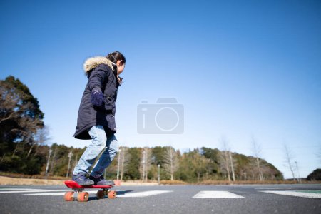 Girl playing on a skateboard
