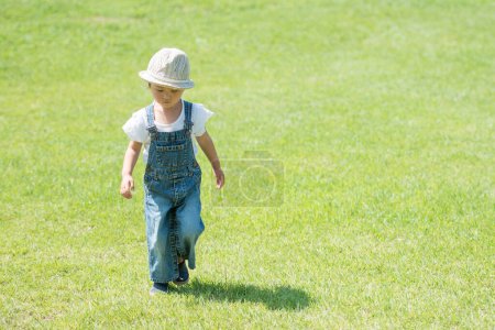 Photo for Girl playing on the lawn - Royalty Free Image