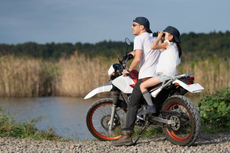 Father and daughter riding two seater off road bike