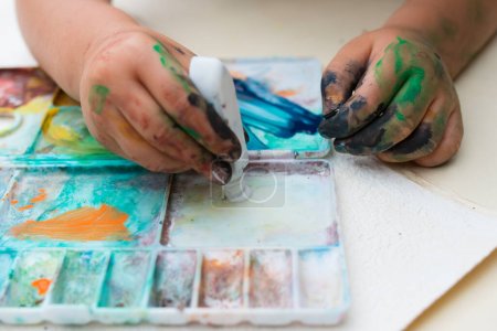 Photo for Child playing in the paint - Royalty Free Image