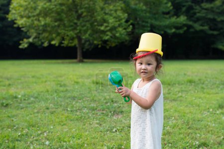Photo for Girl carrying a bucket on the head - Royalty Free Image