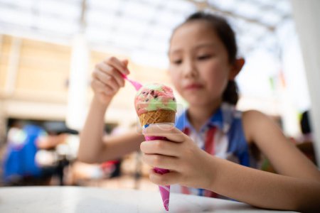 Photo for Girl eating colorful ice cream - Royalty Free Image
