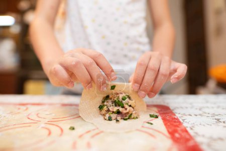 Photo for Hands of child making dumplings - Royalty Free Image