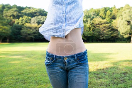 Photo for Stomach of slim woman outdoors - Royalty Free Image