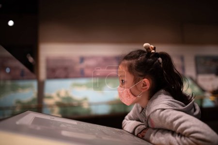 Photo for Girl to visit the museum wearing a mask - Royalty Free Image