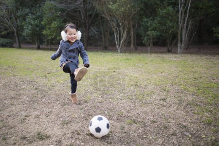 Photo for Happy asian little girl playing with ball  in park, lifestyle concept - Royalty Free Image