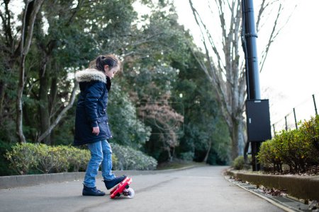 Photo for A girl practicing riding on a caster board - Royalty Free Image