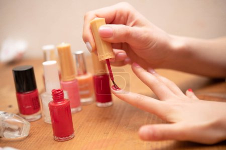 Photo for Mother's hand applying nail polish to her daughter's nails - Royalty Free Image