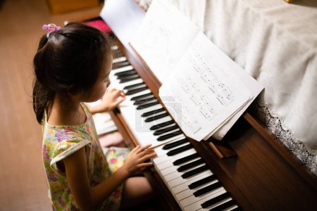 Photo for Girl playing the piano - Royalty Free Image