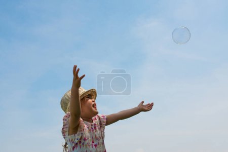 Photo for Girl with soap bubble in the park. - Royalty Free Image
