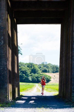 Rural scenery and girl on the other side of the tunnel