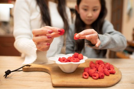 Photo for Mother and child holding raspberries - Royalty Free Image
