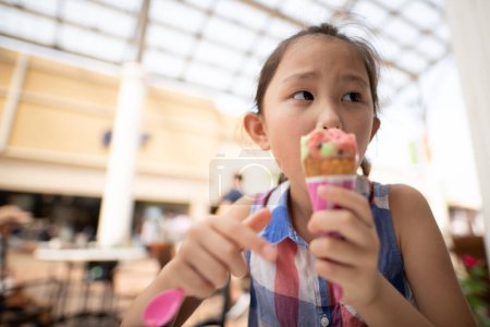 Photo for Girl eating colorful ice cream - Royalty Free Image