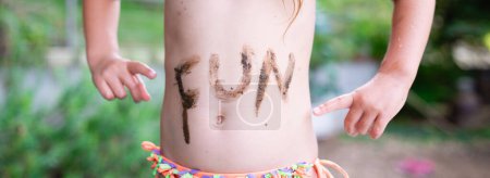 Photo for Child wrote the FUN in the mud in the stomach - Royalty Free Image