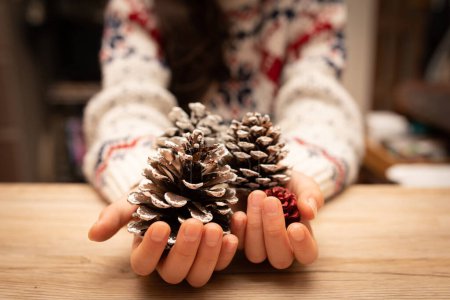 Photo for Children's hands with colored pine cones - Royalty Free Image