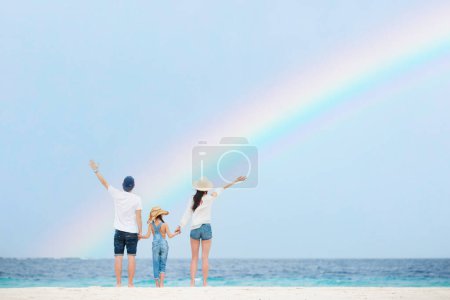 Photo for Family looking up at the sky on the rainbow beach - Royalty Free Image