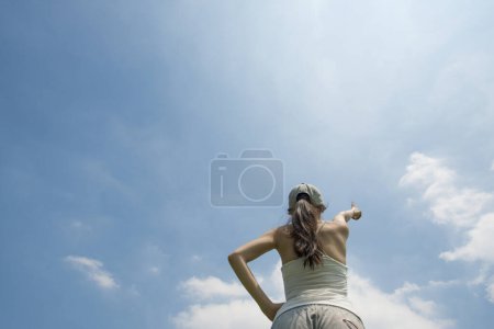 Photo for Woman pointing to blue sky - Royalty Free Image