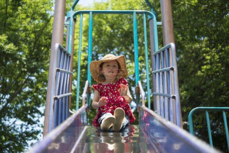 Photo for Girl playing in the slide - Royalty Free Image