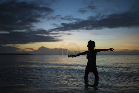 Photo for Silhouette of a cute little asian girl  on the sunset - Royalty Free Image