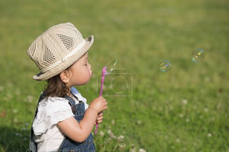 Photo for Girl blowing soap bubbles - Royalty Free Image