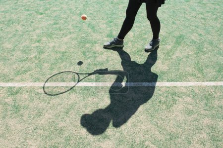 Shadow of female tennis player