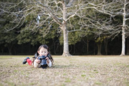Photo for Happy Little Girl taking picture on camera - Royalty Free Image
