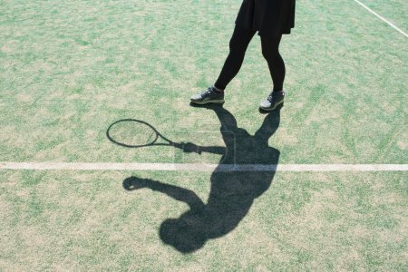 Shadow of female tennis player