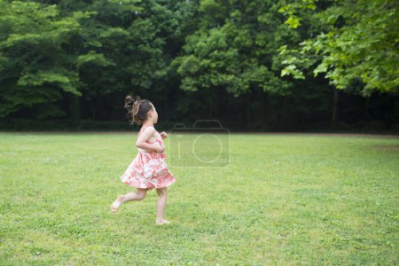 Girl running in the grassland