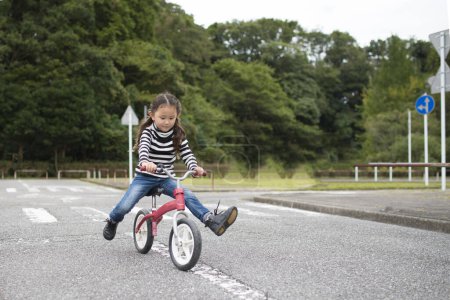 Photo for Little girl riding a bike - Royalty Free Image